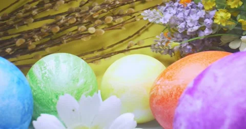 Detailed extreme close-up of multicolored colored eggs on a plate with flowers Stock Footage 150857744