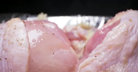 Detailed extreme close-up of the process of cooking spiced chicken legs in foil Stock Footage 151694429