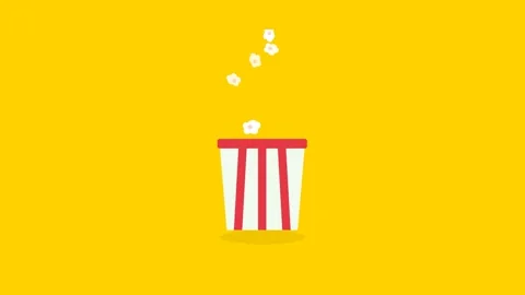 Detailed Fluffy Popcorn Kernels Popping Dynamically in Red Striped Bucket o.. Видео 346007203