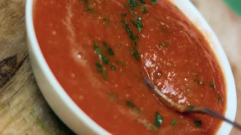 Detailed fresh tomato salsa blended with herbs and garlic in soft focus, 4K Stock Footage 341104366
