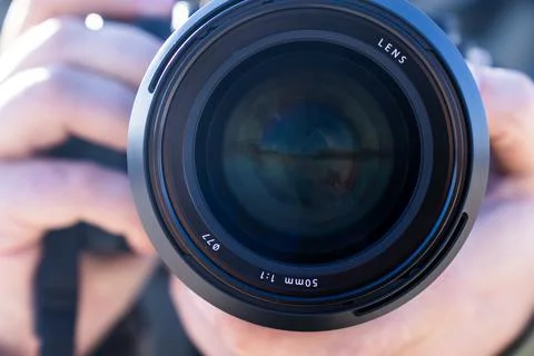 Detailed front view of a camera lens with blue reflections, symbolizing 스톡 사진