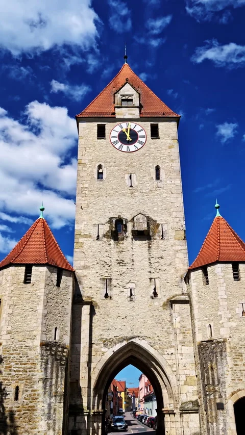 Detailed Front View of Ostentor Clock Gate Tower Under Bright Blue Sky Stock Footage 318198942