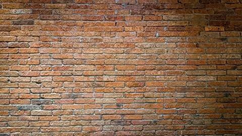 Detailed full frame view of an old brick wall featuring weathered bricks in.. Stock Photos