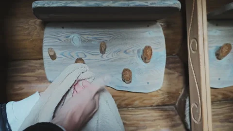 Detailed image captures hands being dried with a soft linen towel in a cozy 動画素材 347293185