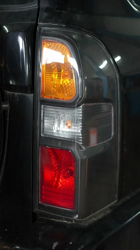 Detailed Inspection of Rear Tail Light During Auto Workshop Maintenance Stock Footage 346337879
