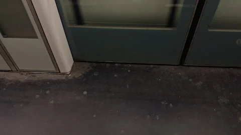 A detailed interior view of a subway car showcasing an unclean floor along with Stock Footage 318496877