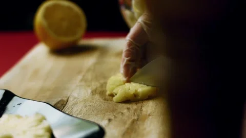 Detailed knife working through tender poultry on a wooden in warm light, 4K Vidéo 341109465