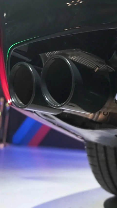 Detailed low-angle shot of dual exhaust pipes and rear diffuser on a modern Stock Footage 340086337
