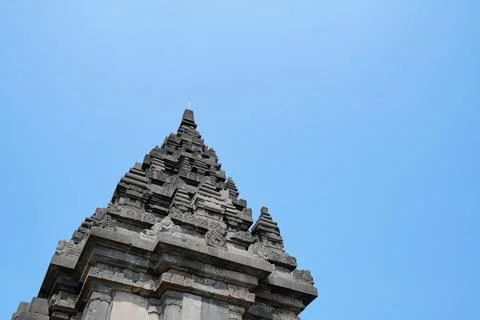 Detailed low angle view of stone spire top architecture at Prambanan temple. Stock-Fotos
