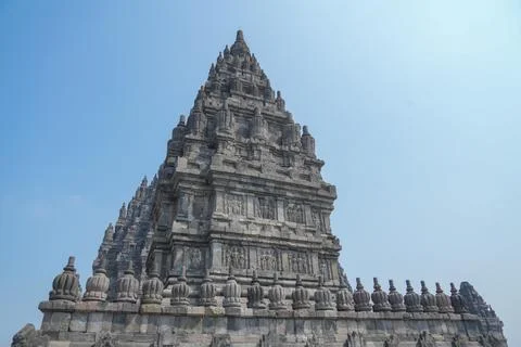 Detailed low angle view of stone spire top architecture at Prambanan temple. Stockfoto's
