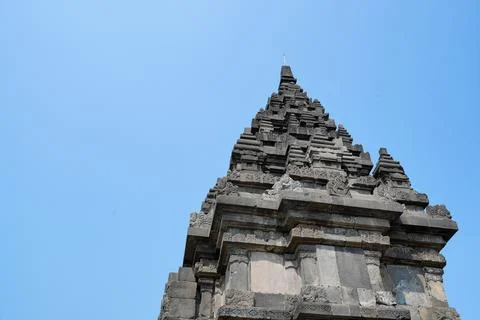 Detailed low angle view of stone spire top architecture at Prambanan temple. 스톡 사진