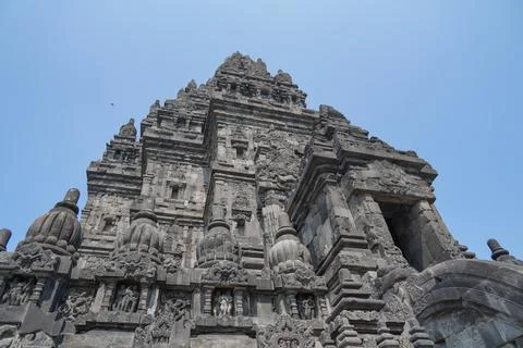 Detailed low angle view of stone spire top architecture at Prambanan temple. Stock Photos