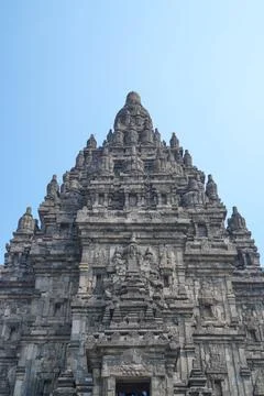 Detailed low angle view of stone spire top architecture at Prambanan temple. Stock Photos