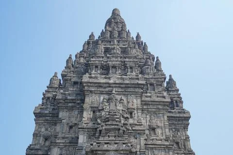 Detailed low angle view of stone spire top architecture at Prambanan temple. Stockfoto's