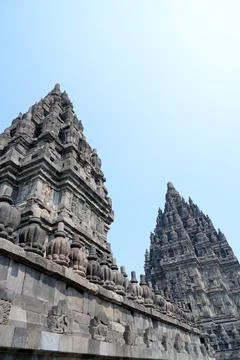 Detailed low angle view of stone spire top architecture at Prambanan temple. Stock Photos