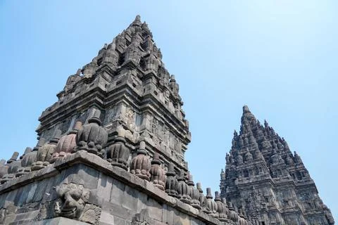 Detailed low angle view of stone spire top architecture at Prambanan temple. Stock-Fotos
