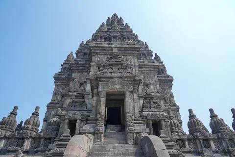 Detailed low angle view of stone spire top architecture at Prambanan temple. Stock Photos