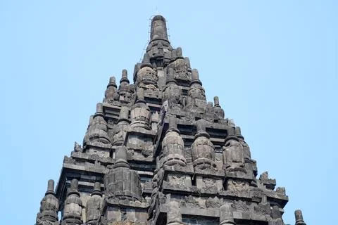 Detailed low angle view of stone spire top architecture at Prambanan temple. 스톡 사진