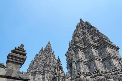 Detailed low angle view of stone spire top architecture at Prambanan temple. Stock-Fotos