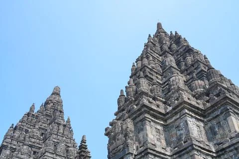 Detailed low angle view of stone spire top architecture at Prambanan temple. 스톡 사진