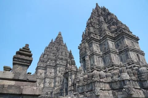 Detailed low angle view of stone spire top architecture at Prambanan temple. Stock-Fotos