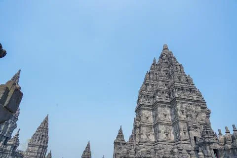 Detailed low angle view of stone spire top architecture at Prambanan temple. Stock-Fotos