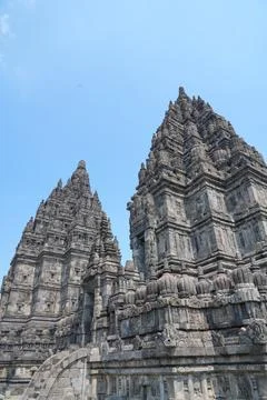 Detailed low angle view of stone spire top architecture at Prambanan temple. 스톡 사진