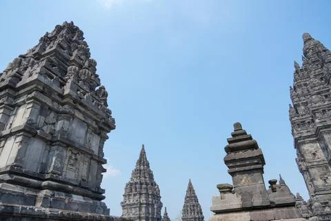 Detailed low angle view of stone spire top architecture at Prambanan temple. 스톡 사진