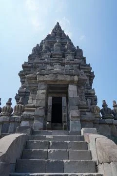 Detailed low angle view of stone spire top architecture at Prambanan temple. Stock-Fotos
