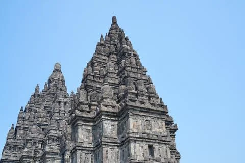 Detailed low angle view of stone spire top architecture at Prambanan temple. Stockfoto's