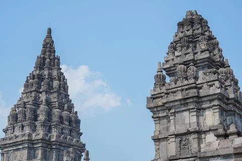 Detailed low angle view of stone spire top architecture at Prambanan temple. Stock Photos