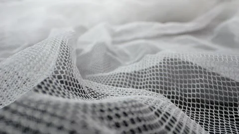 Detailed macro footage showcasing the texture of white lace curtain fabric .. Video stock 259229508