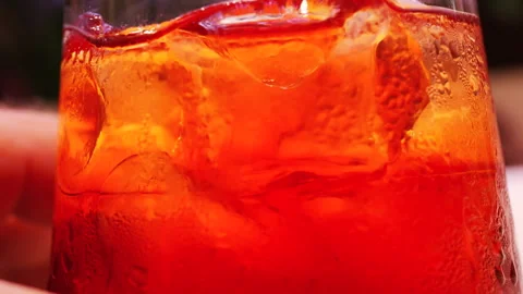 Detailed macro of a refreshing cocktail with ice cubes and water droplets on Stock Footage 332683104