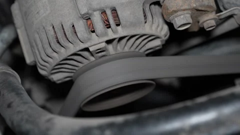 Detailed Macro Shot of Engine Belt and Pulley System During Car Maintenance Work Stock Footage 346338727