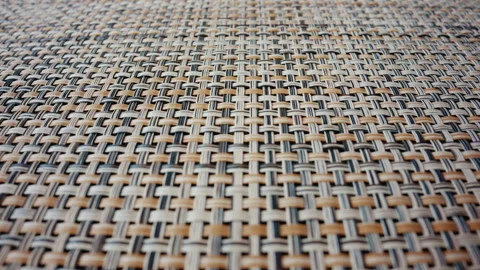 A detailed macro shot of a woven material reveals an intricate pattern of Stock Footage 336823249
