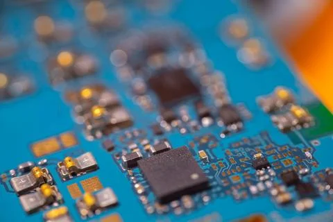 Detailed macro view of blue electronic circuit board with central microchip.. Stock-Fotos