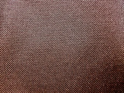Detailed macro view of coarse copper woven textile grid texture serving as ru Stock Photos
