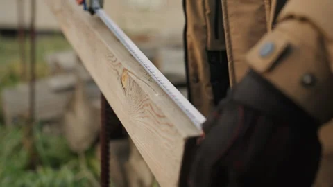 Detailed measurement process for repairing rustic wooden planks. Surveying aged Stock Footage 332504904