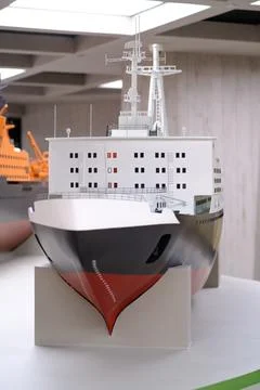 Detailed model of a cargo ship displayed on a table, showcasing intricate d.. Stock Photos