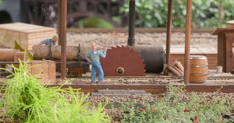 Detailed Model Train Set in Miniature Town with Sawmill Cutting Log Vídeo Stock 99462923