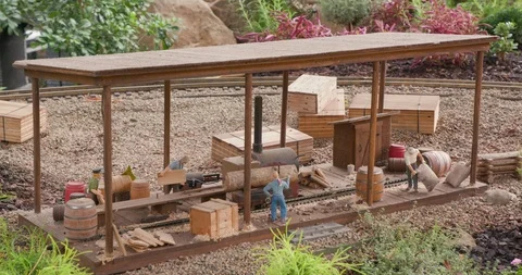 Detailed Model Train Set in Miniature Town with Sawmill Cutting Log Video stock 99463103