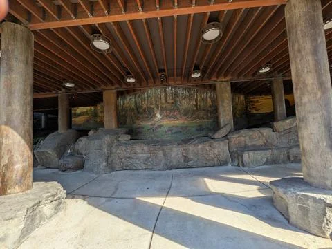 Detailed mural beneath a supported structure depicts river wildlife 库存照片