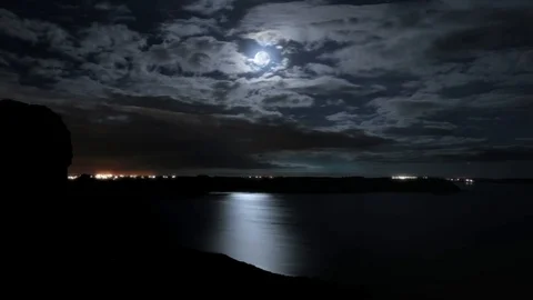 Detailed night moon time-lapse.  Moon reflected in the ocean Stock Footage 99059463