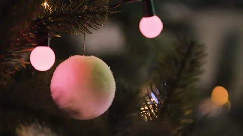 Detailed nighttime holiday background featuring Christmas tree ornaments Stock Footage 344889388