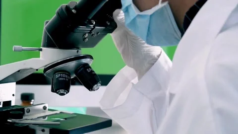 Detailed observation of rotavirus under a microscope is essential for research Stock Footage 336583636