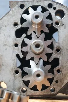 Detailed overhead view of three interlocking steel gears inside a mechanica.. Stock Photos