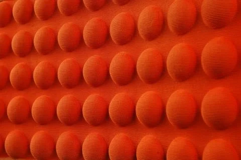 Detailed pattern of orange and brown seat cushion Stockfoto's