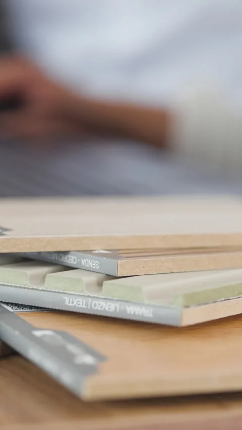 Detailed plan of material and finish samples stacked on a desk Stock Footage 344089176