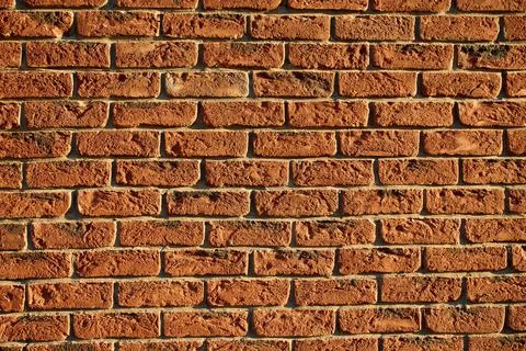 Detailed red brick wall background with structured masonry joints Stock Photos