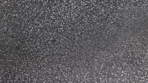 Detailed rotating close-up of dark silver paint specialized sandy texture and Stock Footage 327603811